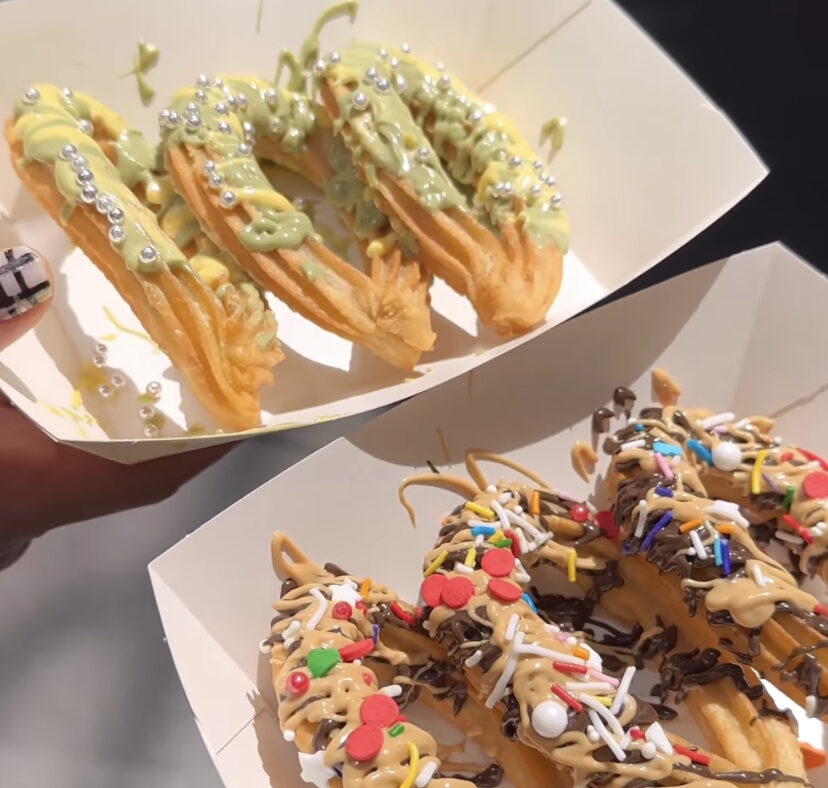 Curved Churros topped with various toppings at Nibbles Desserts